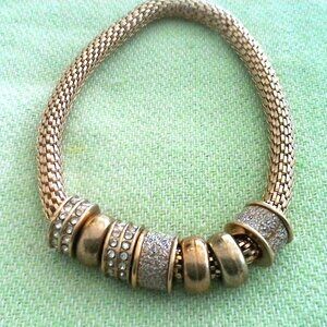 Goltone stretch bracelet with floating charms